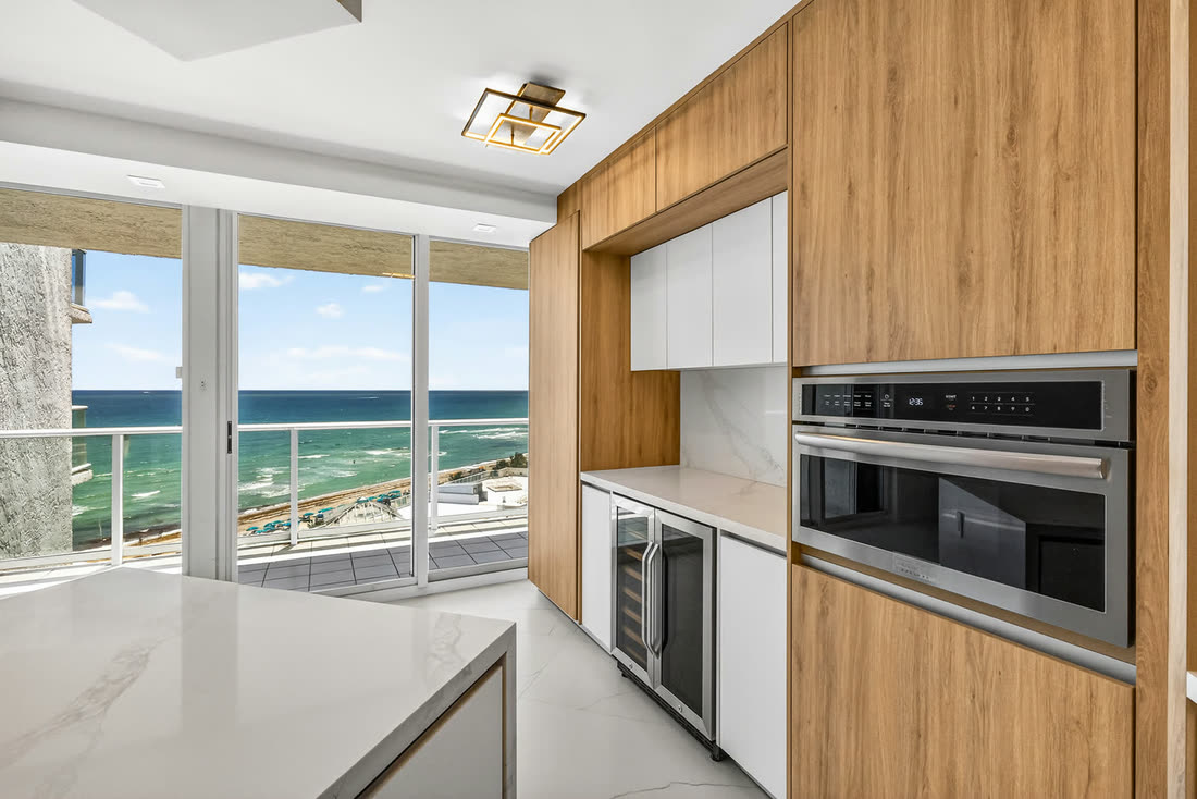 Renovated kitchen with built-in appliances and ocean-view balcony, Oceania II Unit 922