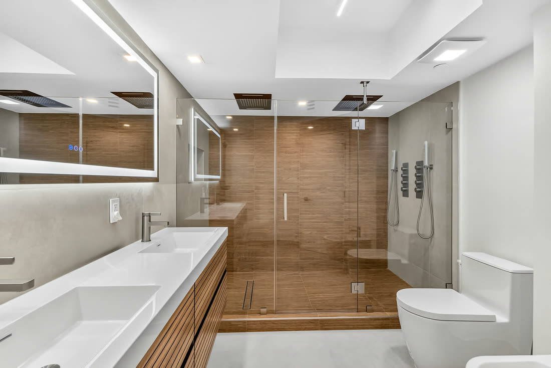 Renovated primary bathroom with glass-enclosed shower, Oceania II Unit 922