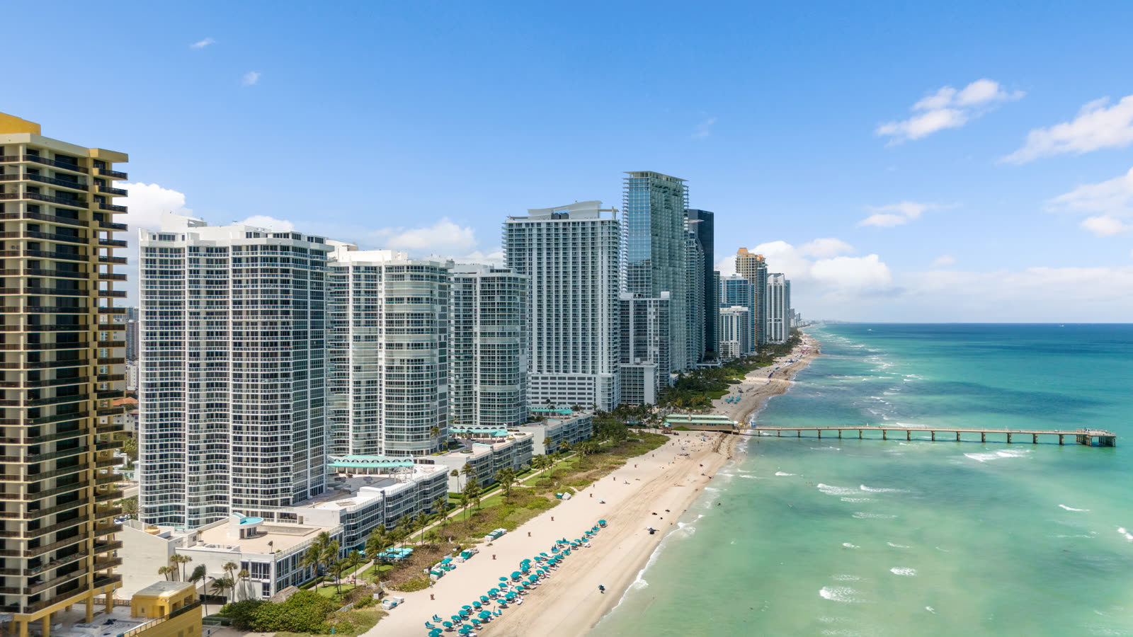 Aerial view of the oceanfront condo tower line along Collins Avenue in Sunny Isles Beach, Florida